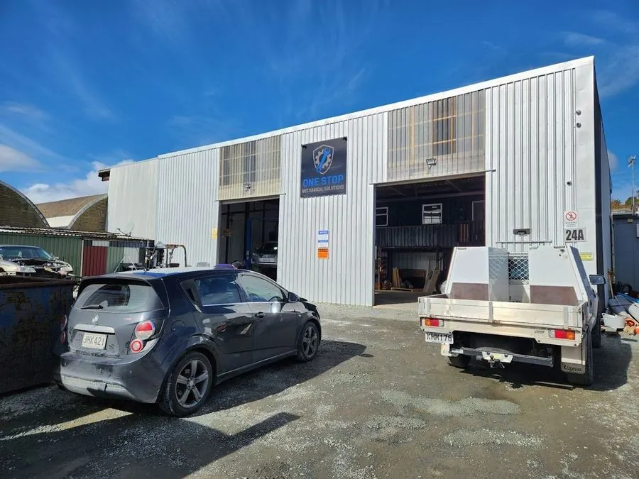 The One Stop Mechanical workshop at Te Kamo, Whangārei with the doors open and the service ute out front