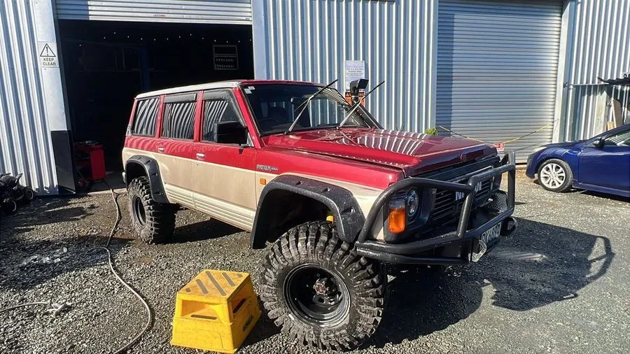 Lifted Nissan Patrol on mud tyres outside the workshop